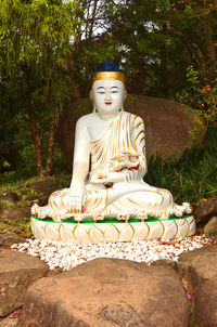 Statue of buddha against trees