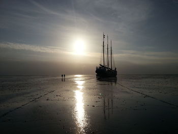 Sailboat in sea at sunset