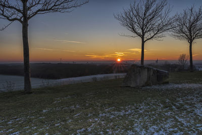 Scenic view of snow field against sky during sunset