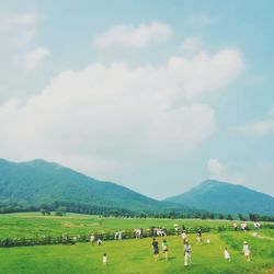 Scenic view of grassy field against cloudy sky