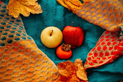 High angle view of fruits and leaves on table