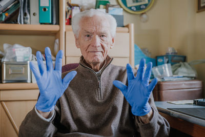 Portrait of senior woman sitting at home