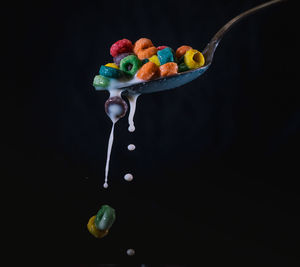 Close-up of multi colored candies against black background