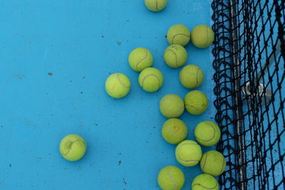 High angle view of multi colored balls on blue background