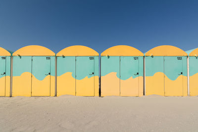 Row of yellow lines against clear blue sky