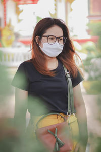 Woman wearing mask while standing outdoors