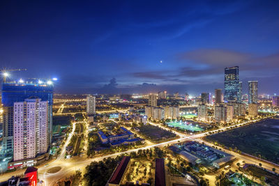 High angle view of illuminated buildings against sky at night