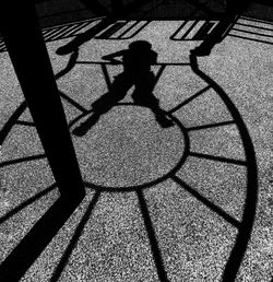 Low section of silhouette person shadow on floor