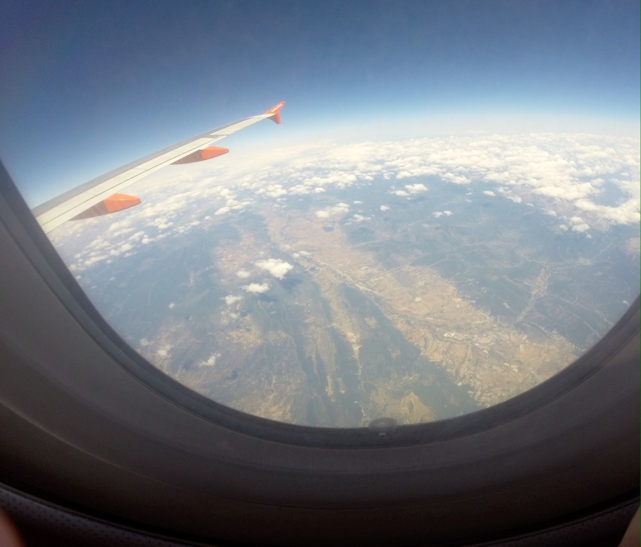 air vehicle, airplane, transportation, flying, aircraft wing, mode of transport, aerial view, mid-air, travel, part of, journey, cropped, landscape, public transportation, on the move, vehicle interior, sky, mountain, window, aeroplane