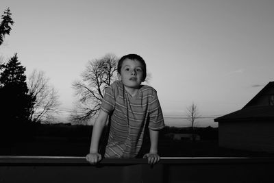 Portrait of boy standing against clear sky