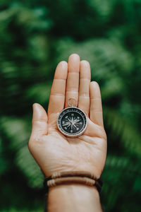 Close-up of hand holding clock