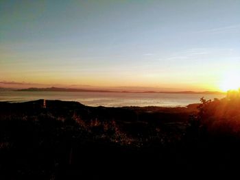 Scenic view of silhouette landscape against sky during sunset