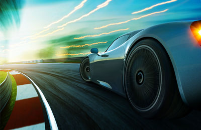 Close-up of car on road against sky