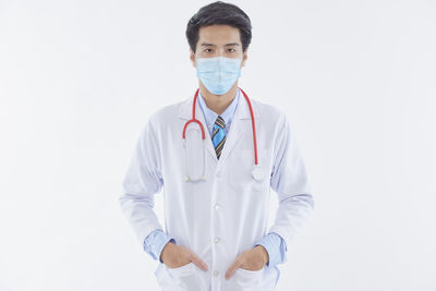 Portrait of man standing against white background