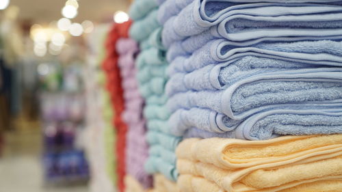 Stack of towels with blur background displayed at shopping mall.