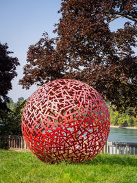 View of red ball on grass in park