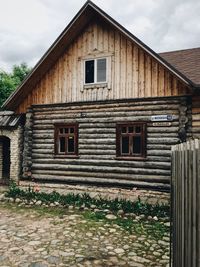 Exterior of old house on field against sky