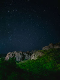 Low angle view of mountain against sky at night