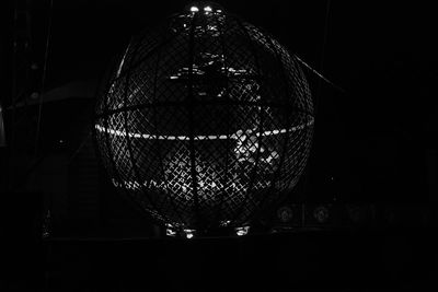 Close-up of illuminated wine glass on table at night