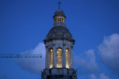 Low angle view of bell tower against blue sky