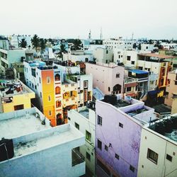 High angle view of houses in city against sky