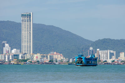 Sea with buildings in background