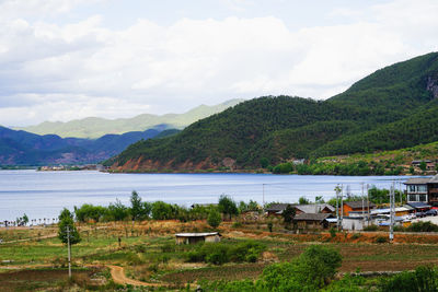 Scenic view of lake and mountains against sky