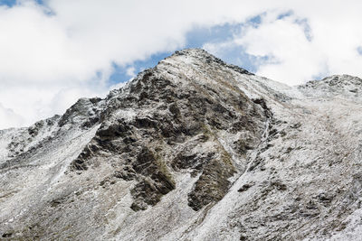 Low angle view of snowcapped mountain against sky