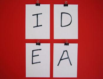 Close-up of information sign on red wall