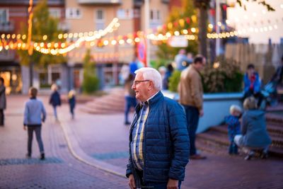 Man standing on road in city