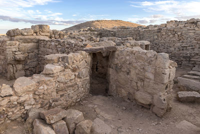 View of old ruins against cloudy sky