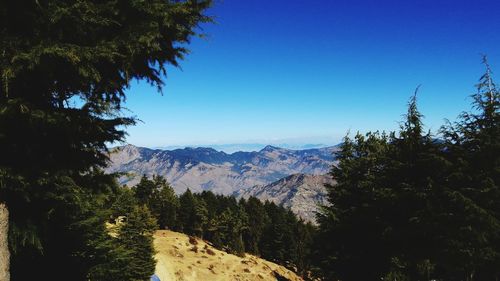 Scenic view of mountains against clear blue sky