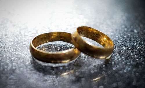 Close-up of wedding rings on table