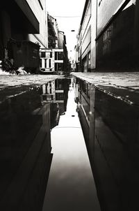 Canal amidst buildings against sky