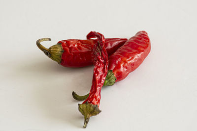 Close-up of red chili pepper over white background