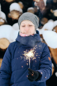 Girl holding sparkler in park