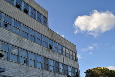 Low angle view of office building against blue sky