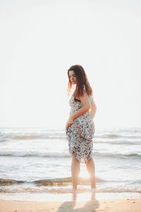 Young woman standing at beach