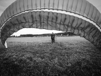 People walking on field against sky