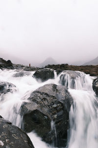 Scenic view of waterfall against sky