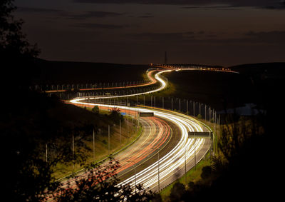 High angle view of light trails on road at night