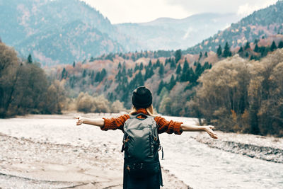 Rear view of man standing on shore