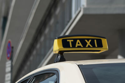 Close-up of yellow car on road