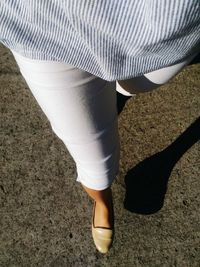 Low section of woman standing on ground