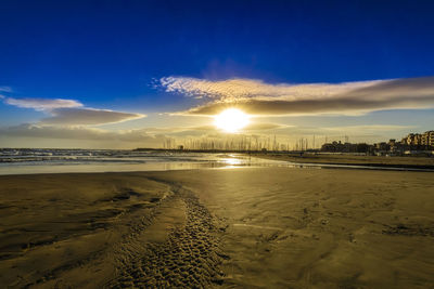 Scenic view of beach against sky during sunset
