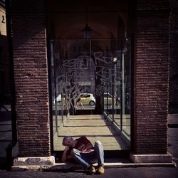 Man sleeping in front of building