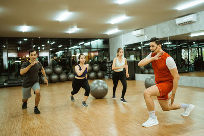 Rear view of people exercising in gym