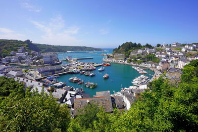 High angle view of townscape by sea against sky