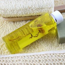 High angle view of oil bottle by brush on rug