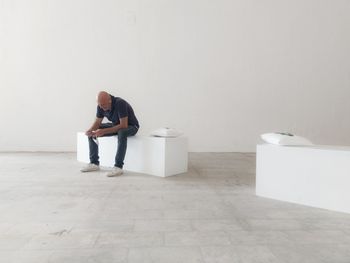 Rear view of woman standing in bathroom